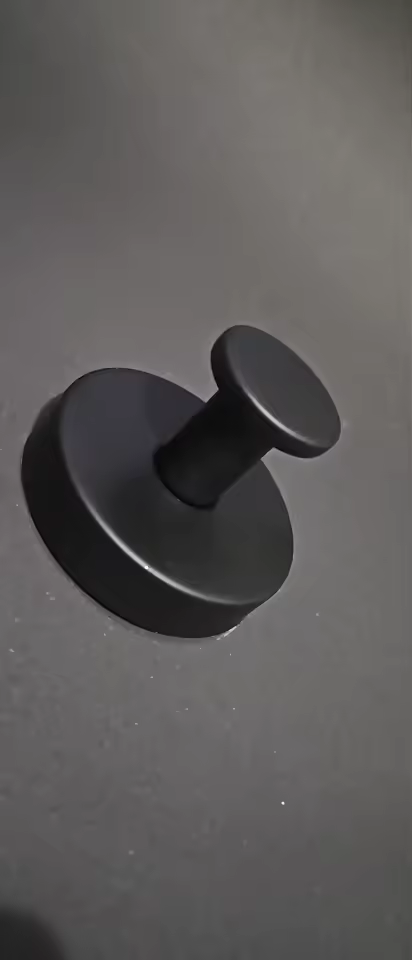 Close-up of a matte black suction hook